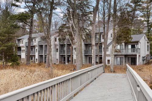 a boardwalk leading to a large white building at The Shores in Williamsburg
