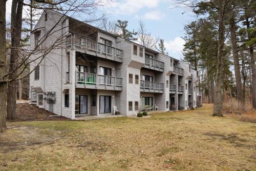 a large white building with balconies and trees at The Shores in Williamsburg