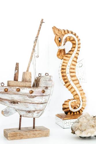a wooden boat and a seahorse on display at Driftwood Callala Plus - Jervis Bay Getaway - 10 Guests! in Callala Bay