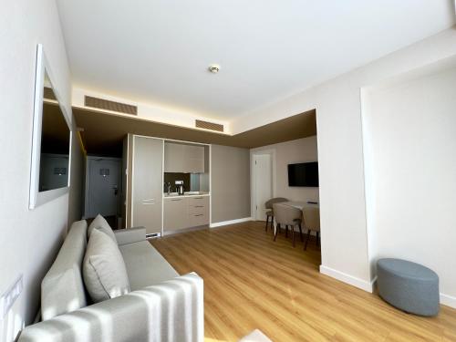 a living room with a couch and a dining room at My Sunshine Apartments in Batumi in Batumi