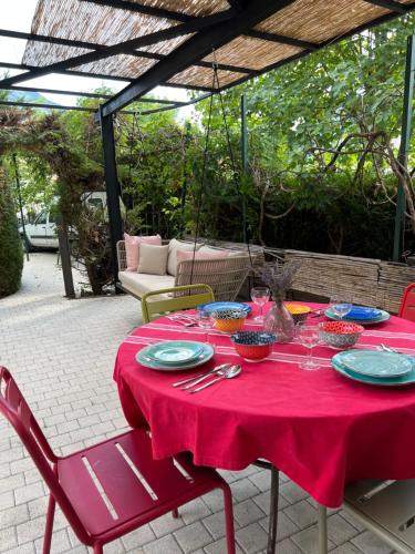 a red table with plates of food on it at La tour de guet Maison atypique in Castellane