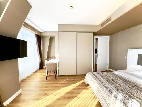 a hotel room with a bed and a table at My Sunshine Apartments in Batumi in Batumi