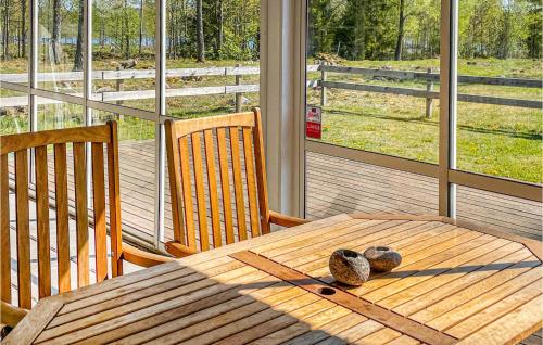 a wooden table with rocks on it on a porch at 3 Bedroom Nice Home In Vittaryd in Kvänarp