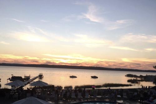 a sunset over a lake with boats in the water at The Shores in Williamsburg