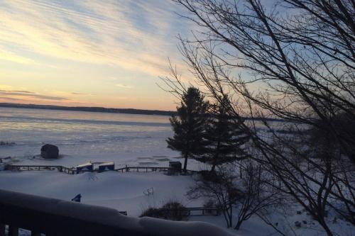 a winter view of a lake with snow on the ground at The Shores in Williamsburg