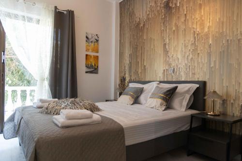 a bedroom with a bed with two towels on it at Astradeni Suite in Nea Potidaea