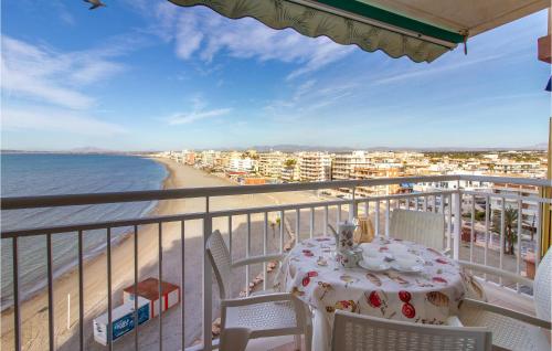 a table on a balcony with a view of the beach at 2 Bedroom Cozy Apartment In Santa Pola in Santa Pola
