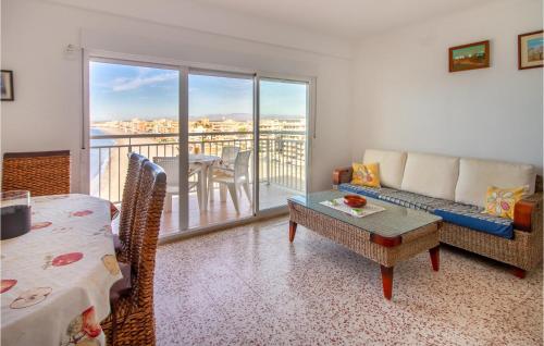 a living room with a couch and a table and a balcony at 2 Bedroom Cozy Apartment In Santa Pola in Santa Pola