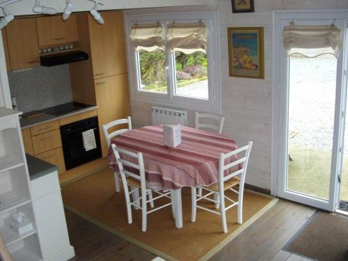 une salle à manger avec une table et des chaises dans une cuisine dans l'établissement La voile blanche, à Berneval-le-Grand