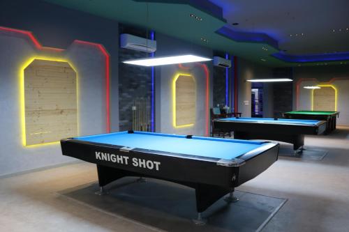 two snooker tables in a room with at Palma Beach Resort & Spa in Umm Al Quwain