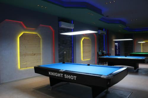 a pool table in a room with two pool tables at Palma Beach Resort & Spa in Umm Al Quwain