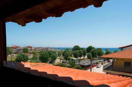 a view of a city from a building at Dionisos Roses in Paralia Dionysiou