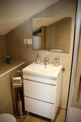 a bathroom with a white sink and a mirror at Buhardilla barranquilla in Poyales del Hoyo