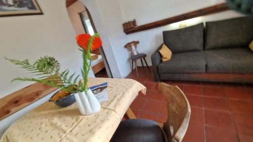 a table with a vase with a flower on it at Schmiedhof in Seefeld in Tirol
