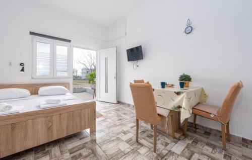 a bedroom with a bed and a desk and a table and chair at Apartments Marija with big garden - TA Leut Agency in Vrsi