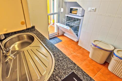 a kitchen with a sink and two trash cans at Beachfront Duplex 1ª línea & Terraces Oceanfront in El Puerto de Santa María