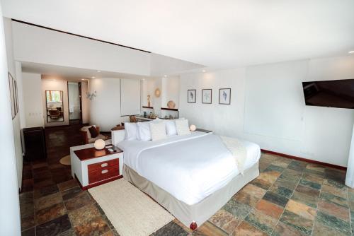 Ένα ή περισσότερα κρεβάτια σε δωμάτιο στο Hotel Villa Escalesia Galapagos