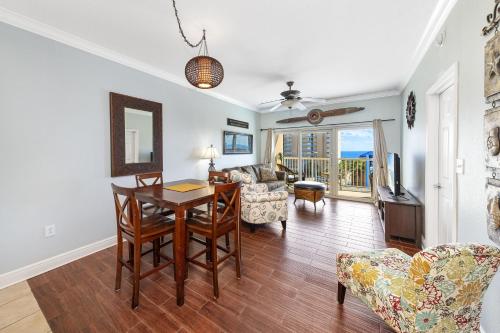 a living room with a table and chairs and a couch at Crystal Tower Condos in Gulf Shores