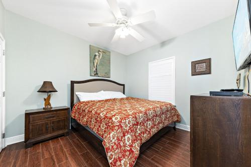 a bedroom with a bed and a ceiling fan at Crystal Tower Condos in Gulf Shores