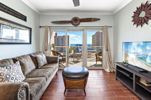 a living room with a couch and a flat screen tv at Crystal Tower Condos in Gulf Shores