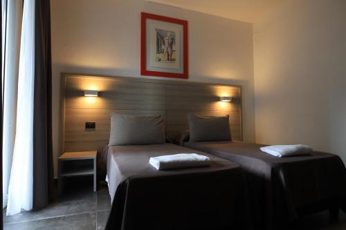 a bedroom with two beds in a room at Tiby Hotel in Modena