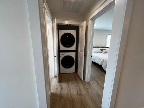 a hallway leading to a bedroom with a washing machine at Montgomery Modern Luxury Stays in Montgomery