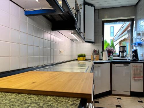 a kitchen with a wooden counter top in a room at Barrierefreies Ferienhaus mit Garten bei Köln in Hürth