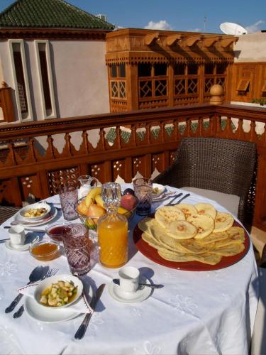 a table with a plate of food on it at Riad Flam & Spa in Marrakech
