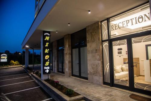 a store front of a building with a white couch in the window at Apartments NIKOS FAMILY in Ulcinj