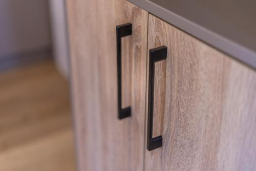 a wooden cabinet with the number on it at Domki - Sosnowy Las in Pobierowo