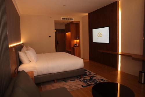 Ένα ή περισσότερα κρεβάτια σε δωμάτιο στο Aglow Hotel Harbor Bay Batam