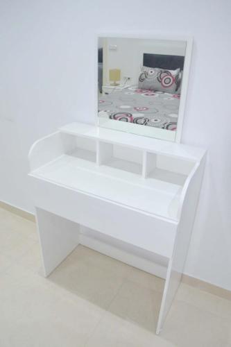 a white shelf with a mirror on top of it at Residence Prague in Al Hoceïma