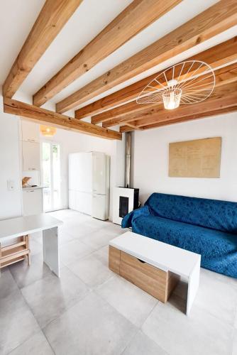 un salon avec un canapé bleu et une table dans l'établissement Mariella - MAISON FAMILIALE, WIFI, 500m de la plage, à Royan