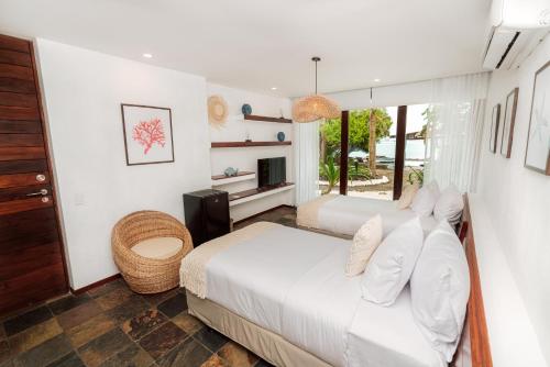 Ένα ή περισσότερα κρεβάτια σε δωμάτιο στο Hotel Villa Escalesia Galapagos