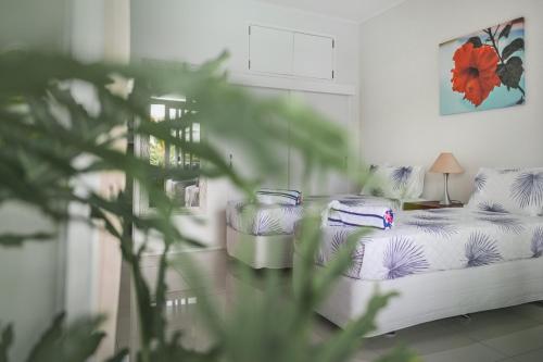 a room with a bed with pillows on it at Avaiki Nui Villa in Avarua