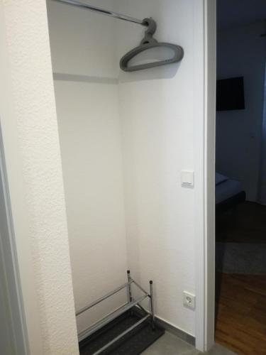 a room with a white wall with a light on it at Am Meerbach in Bensheim