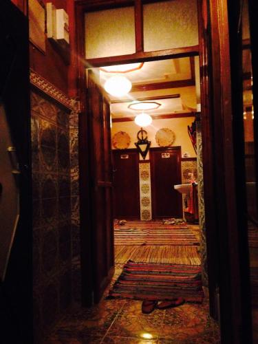 a hallway of a room with a door and a table at Imlil Refuge in Imlil