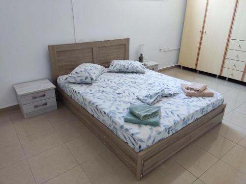 a bedroom with a bed with two towels on it at Mama Marina apartement near to the airport 2 in Antimácheia