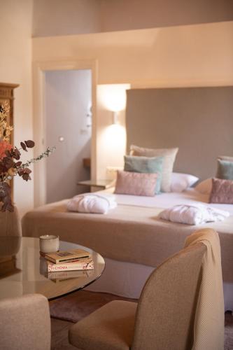 a bedroom with a large bed and a table at La Casa de La Camelia in La Laguna
