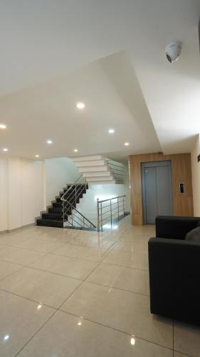 a lobby with a staircase in a building at Hotel Hive Inn - Kozhikode in Kozhikode