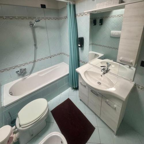 a bathroom with a toilet and a sink and a bath tub at Podere il Casone in Serravalle Pistoiese