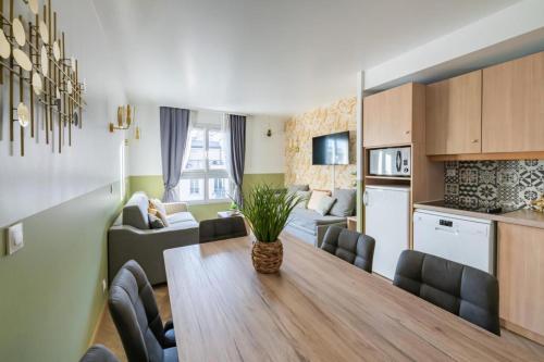 a kitchen and a living room with a table and a living room at Jungle Duplex with pool 5 min Disneyland in Serris