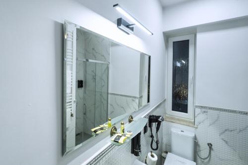 a bathroom with a sink and a mirror at Elegant Apartments in Poznań