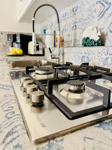 a kitchen with a stove top oven in a kitchen at Butera Apartments Luxury in Palermo