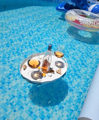 a drink on a tray in a swimming pool at CHALET in Patra