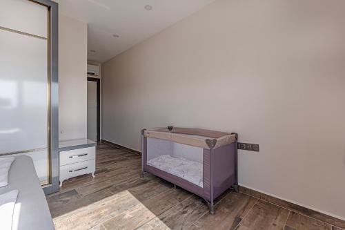 a bedroom with a crib in the corner of a room at Villa Tosun in Belek