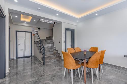 a dining room with a table and chairs at Villa Tosun in Belek