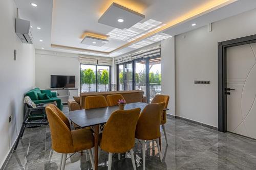 a meeting room with a table and chairs at Villa Tosun in Belek