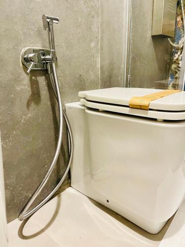 a white toilet in a bathroom with a shower at Butera Apartments Luxury in Palermo