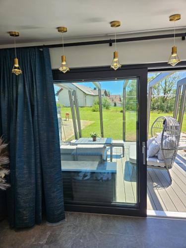 a room with a sliding glass door to a patio at TinyApartament in Skawa